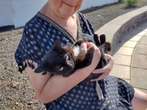 Mary cradling a kitten in her arms