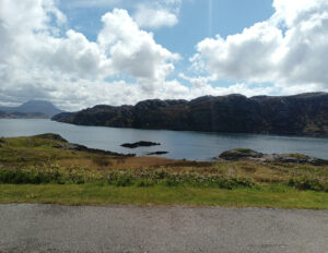 A view of a loch and hillside
